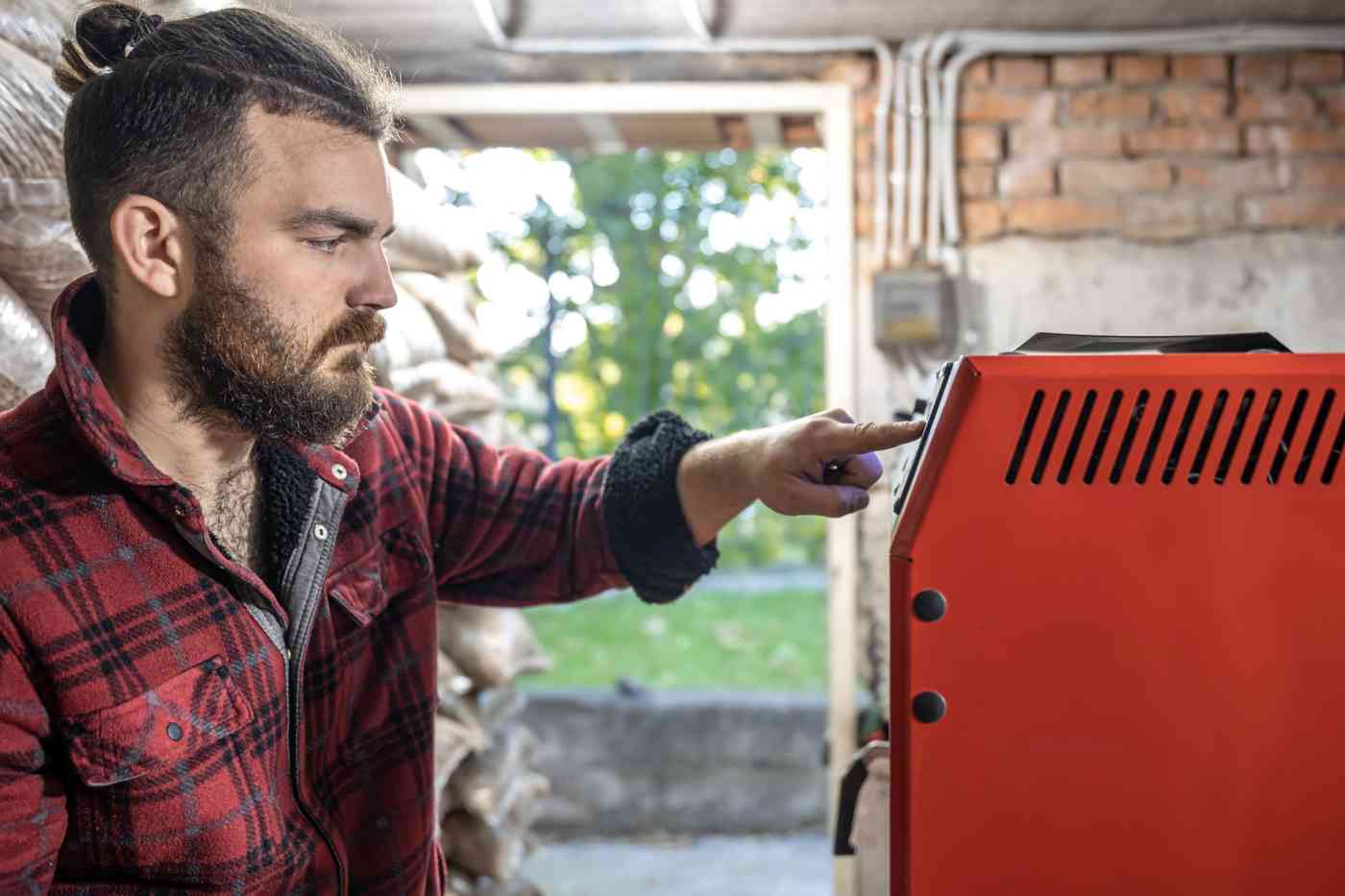 Young man room with solid fuel boiler working biofuel economical heating 1